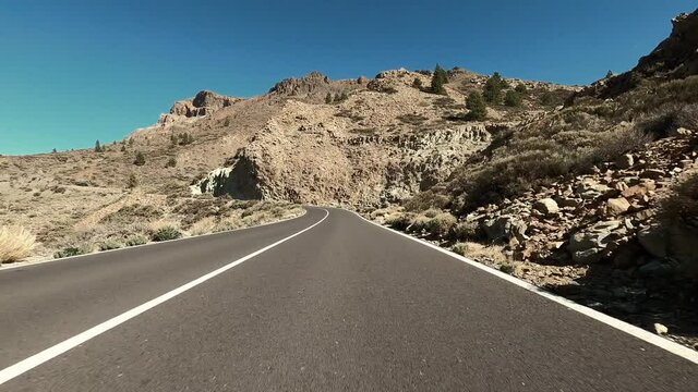 Long asphalt road ground view and travel concept - mountain and sky landscape - outdoor road trip in scenic place background