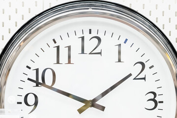 Conceptual image of round clock ,Deadline.Time Management. Time pressure. Cure for old age. Annual reports. Front view.