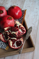 pomegranates on wood and an old and opened grenade knife