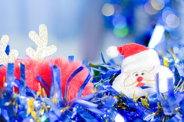 Selective focus photo santa doll for christmas in winter new year Light ornament blue theme blurred background and bokeh.