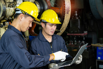 Workers hold Laptop and Discusses Product Details in factory.