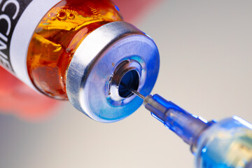 Medical vial with medication and syringe close up