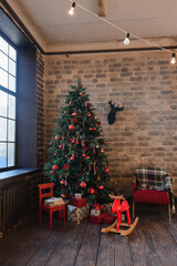 new year's interior with a Christmas tree, window and brick wall