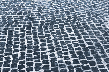 Cobblestone pavement in Winter with snow.