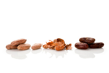 Fresh roasted cocoa beans and peels isolated on white background.