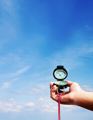 compass in hand blue sky © Anna