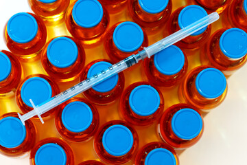 Medication vaccine vials and syringe on white background