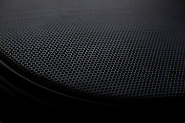 Dark background. Speaker grille. Macro mode.
