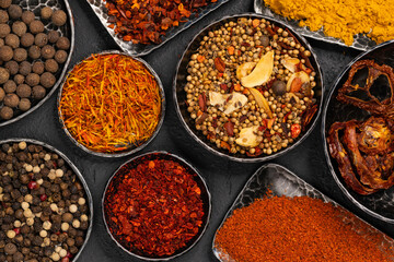 Variety of spices on kitchen table. A set of spices and herbs. Top view.