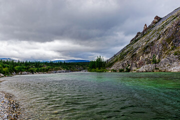 northern river flowing among the rocks in a forest area