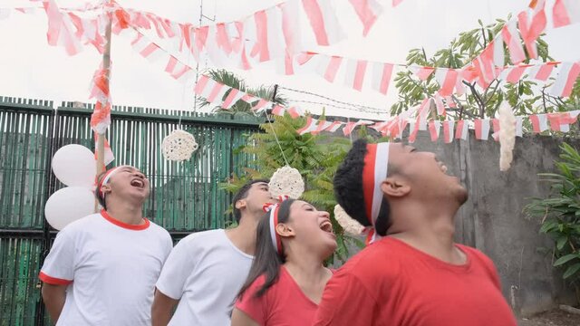 cracker eating competition on Indonesia's Independence Day celebrations in the field with decorated flags