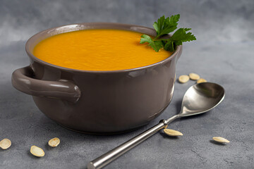 Fresh pumpkin cream soup with sour cream. Autumn lunch concept. A dietary, healthy dish.