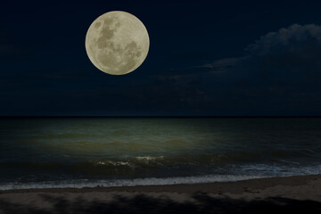 Full moon over sea in the night.