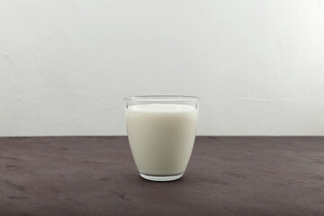 Ayran or kefir in a glass. Fermented milk ayran. Milk diet for weight loss. Selective focus, copy space