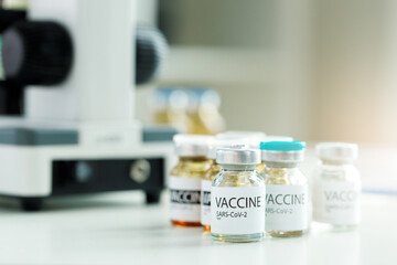 Vial of Covid-19 coronavirus vaccine on table in medical lab