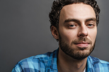 Unshaven handsome guy posing and looking at camera