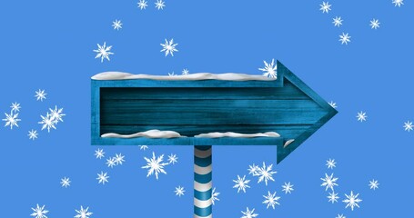 Digital animation of snowflakes falling over blue wooden arrow shaped sign post - Powered by Adobe