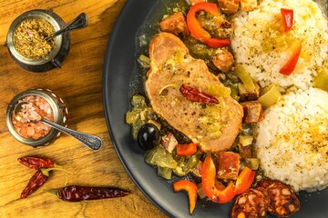  Food and drink concept. Roasted pork chop and rice as main course. Pork with rice and sausage.