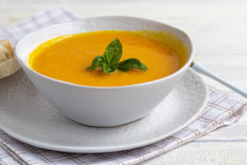 Fresh pumpkin cream soup with sour cream. Autumn lunch concept. A dietary, healthy dish.