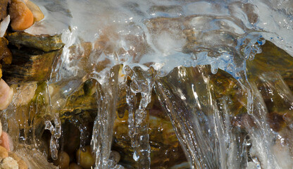 Waterfall running under the ice