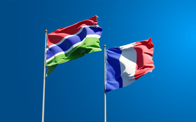 Beautiful national state flags of Cambia and France together at the sky background. 3D artwork concept.