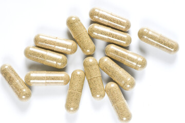 Herb in capsules on white background