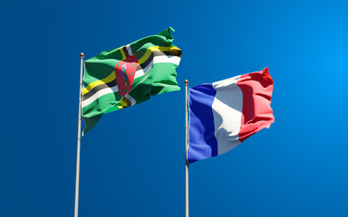 Beautiful national state flags of Dominica and France together at the sky background. 3D artwork concept.
