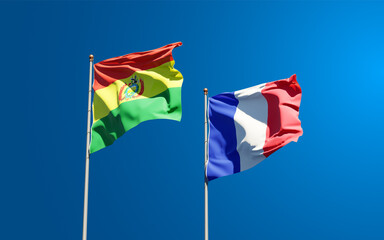 Beautiful national state flags of Bandera de Bolivia and France together at the sky background. 3D artwork concept.