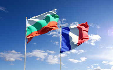 Beautiful national state flags of Bulgaria and France together at the sky background. 3D artwork concept.