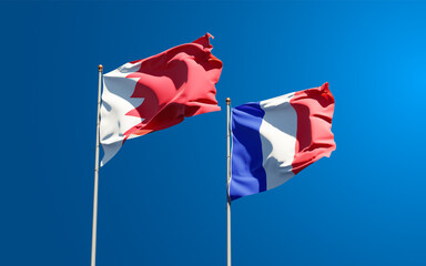 Beautiful national state flags of Bahrain and France together at the sky background. 3D artwork concept.