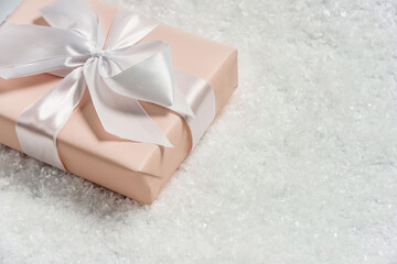 Gift box with a bow in the snow.