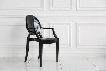 black chair is in white room