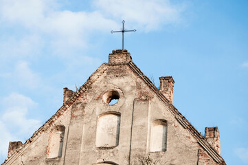 Fototapeta na wymiar ancient Christian church. iron cross on a stone pediment. image illustrates the concept of faith