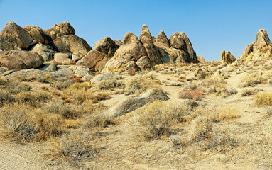 Rocky desert landscape with smooth boulders under a blue sky