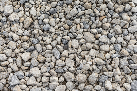 Seamless rough stone gravel texture background.