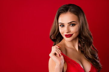 Photo portrait of flirty woman taking off bra isolated on vivid red colored background with blank space