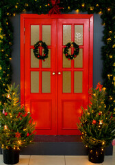 Fototapeta na wymiar red doors with Christmas wreath and Christmas trees