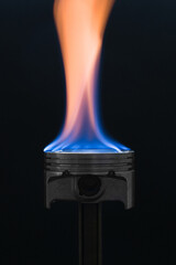 engine piston on fire on dark background