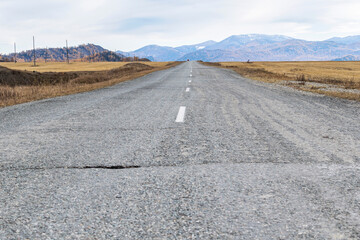 Deserted asphalt road and the landscape of the mountains.