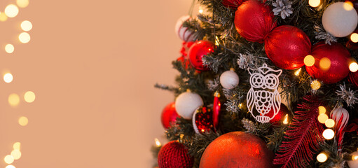 Gold and red Christmas background, greeting card, view with a decorated Christmas tree and space for text