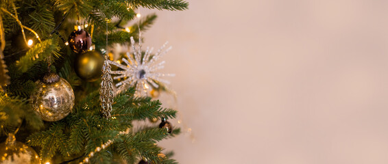 Golden Christmas background banner with a decorated Christmas tree and place for text