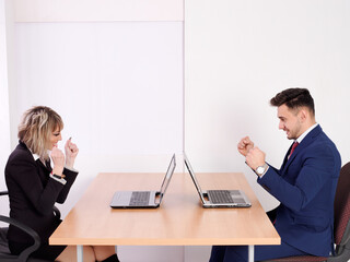 Cheerful and euphoric business staff at seeing good results on the computer