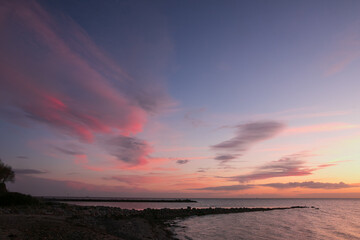 coastline with sea groynes with pink clouds