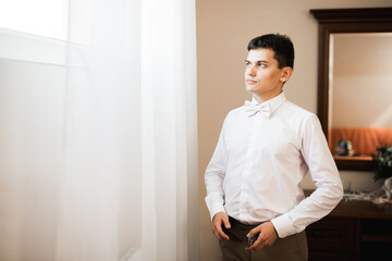 Beautiful man, groom posing and preparing for wedding