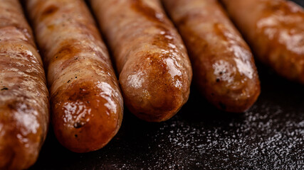 Grilled meat sausages on an open fire.