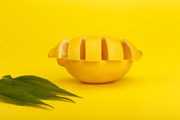 Lemon on yellow background with leaves