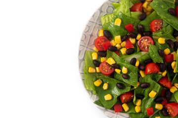 Mexican salad with black beans, corn,tomatoes,lettuce and pepper isolated on white background	