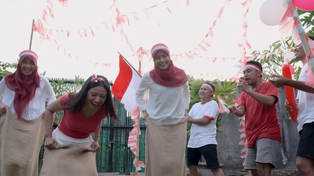 Indonesian girls took part in a sack race supported by spectators on the field during independence day celebration of indonesia
