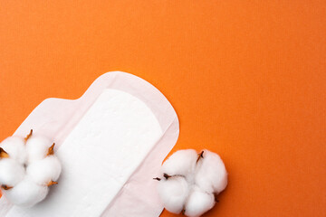 Female hygiene pad and cotton bud on orange background © fotofabrika