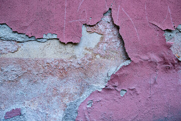 pink grunge wall with cracked paint and cracks